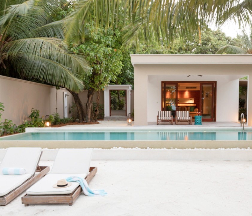 An outside view of our one bedroom villa's pool and sundeck from the beach.