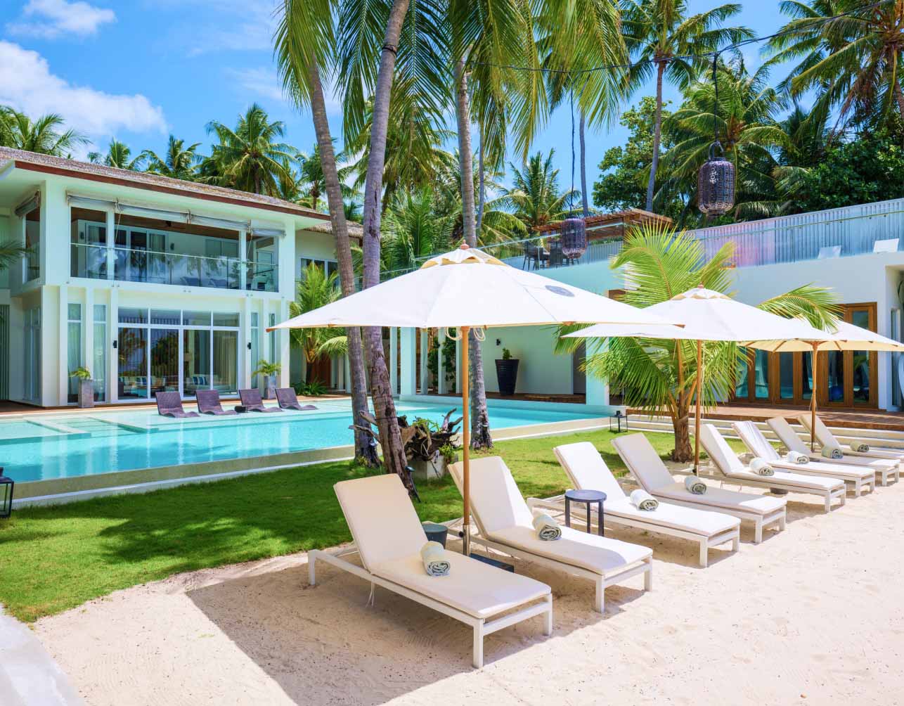 A poolside view of the rooftop bar overlooking the freshwater pool next to secluded beach access at our Maldives Mansion.