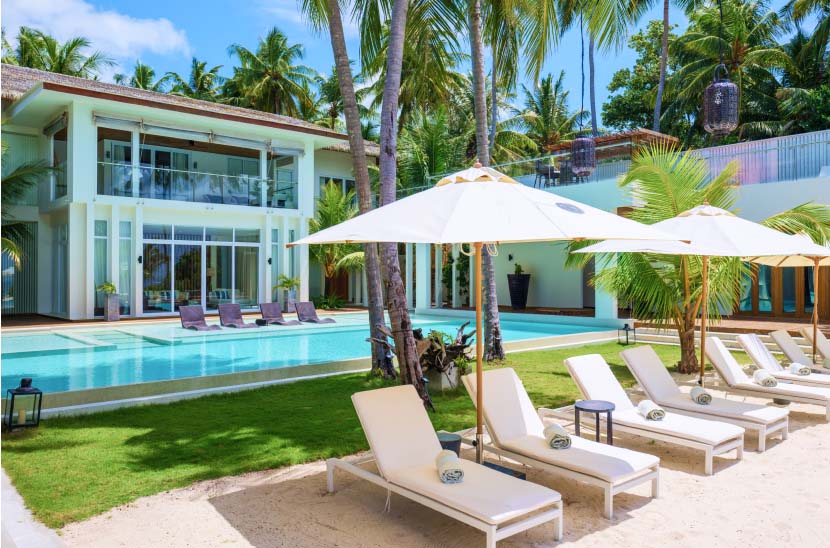 An exterior beachside view of the Amilla Estate - Our premier Maldives Family Accommodation