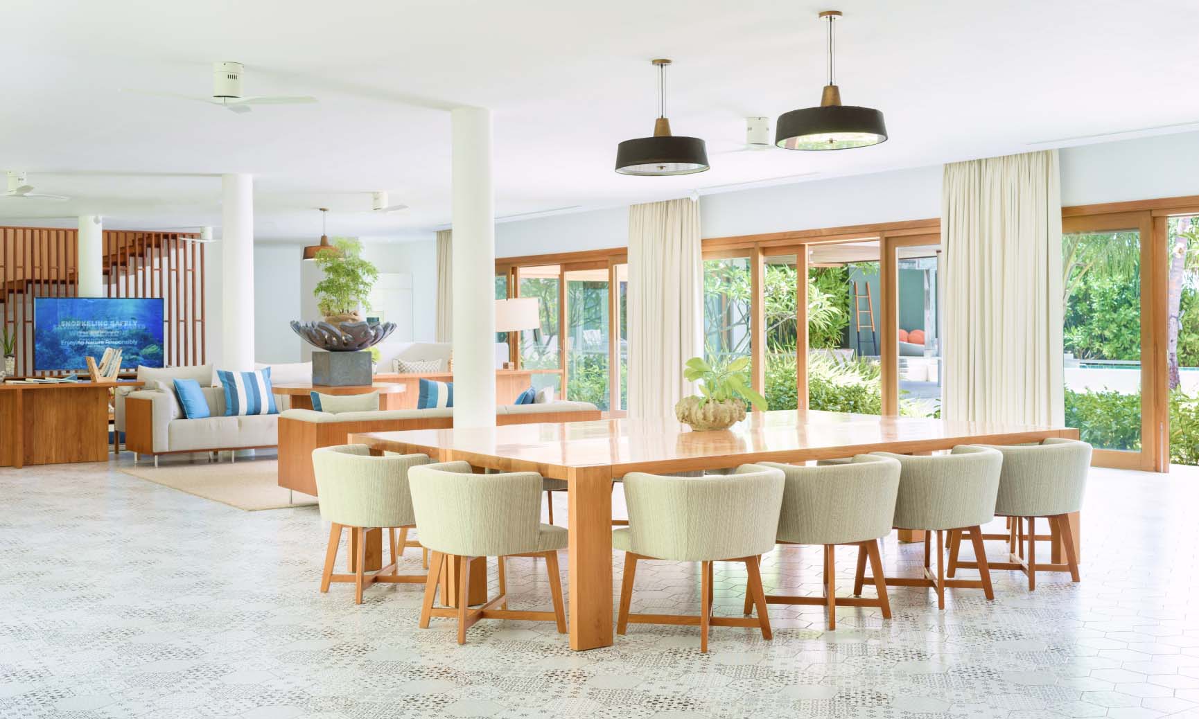 The spacious dining area open to the living room in our Great Beach Residences Maldives.