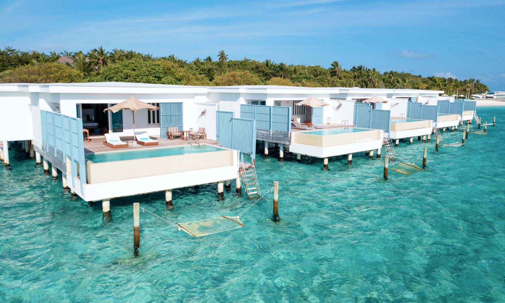An outdoor view of our Sunset Water Villas with private pool and hammock over the ocean.